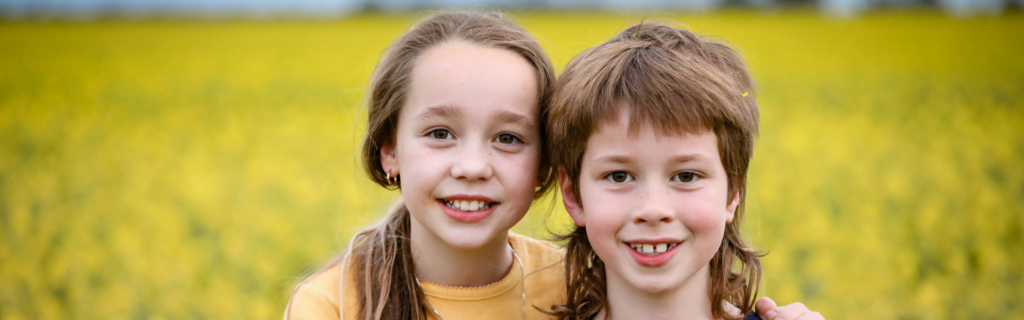 Children Smiling in a Field